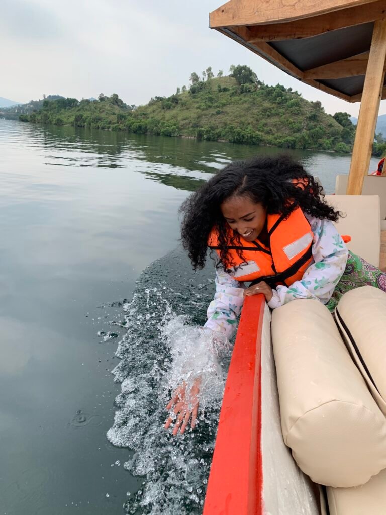 Visitors relaxing on a boat, taking in the beauty and fresh air of Lake Kivu.