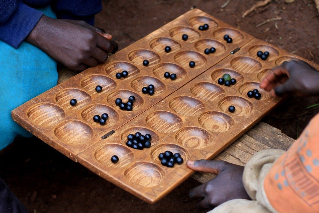 Discover Igisoro and Kubuguza, Rwanda’s ancient traditional strategy game. Learn the meaning of Nteba, Ngarama, Guteba, and explore authentic cultural experiences in Rwanda and Lake Kivu communities.